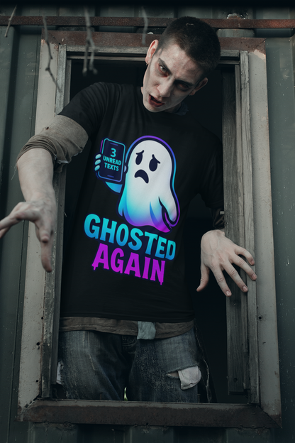 A man wearing a black graphic t-shirt with a ghost design and the text 'GHOSTED AGAIN' leans out of a dark, weathered window. The shirt features a glowing blue and purple ghost graphic holding a phone with '3 MORE TEXTS' and the words 'GHOSTED AGAIN' in a neon blue and purple gradient.
