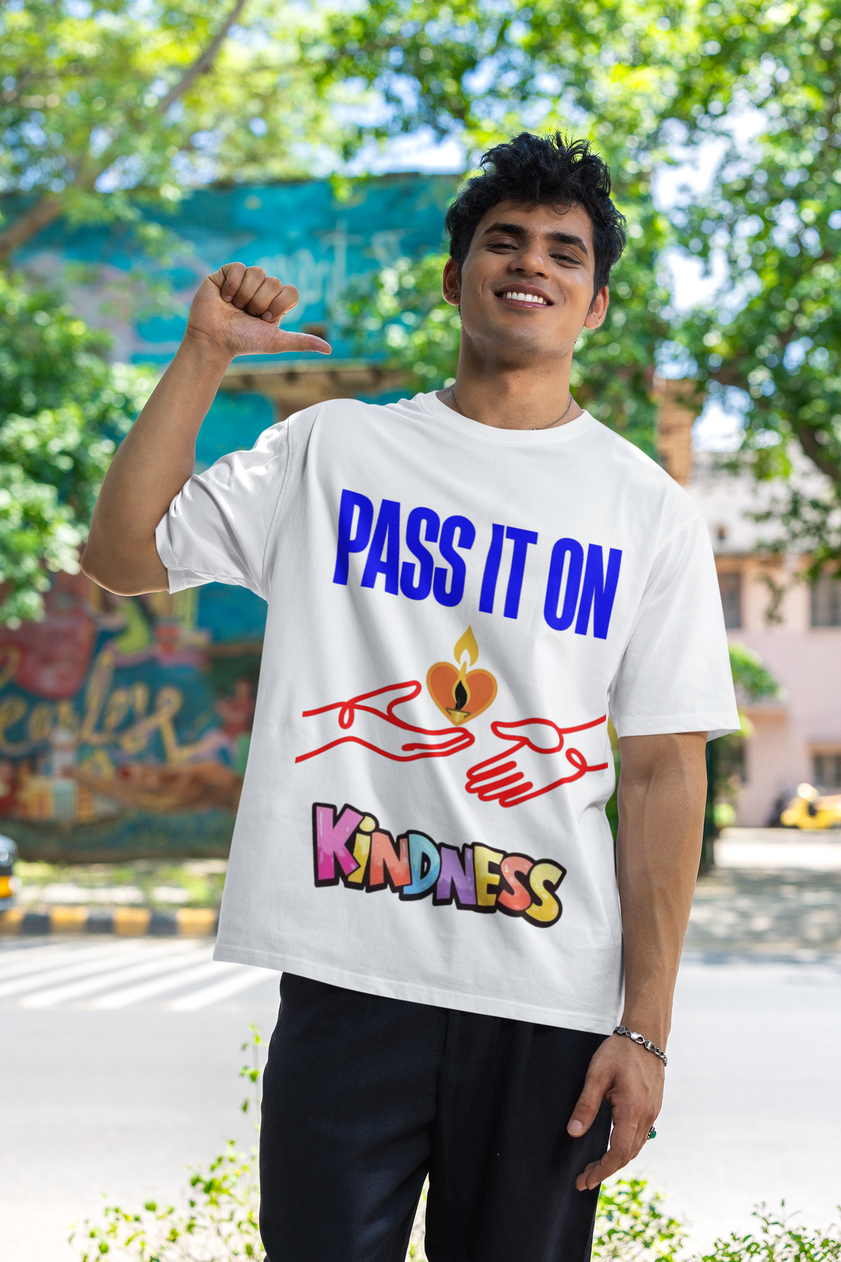 Pass It On positive message graphic t-shirt worn by blinkstore smiling man pointing himself