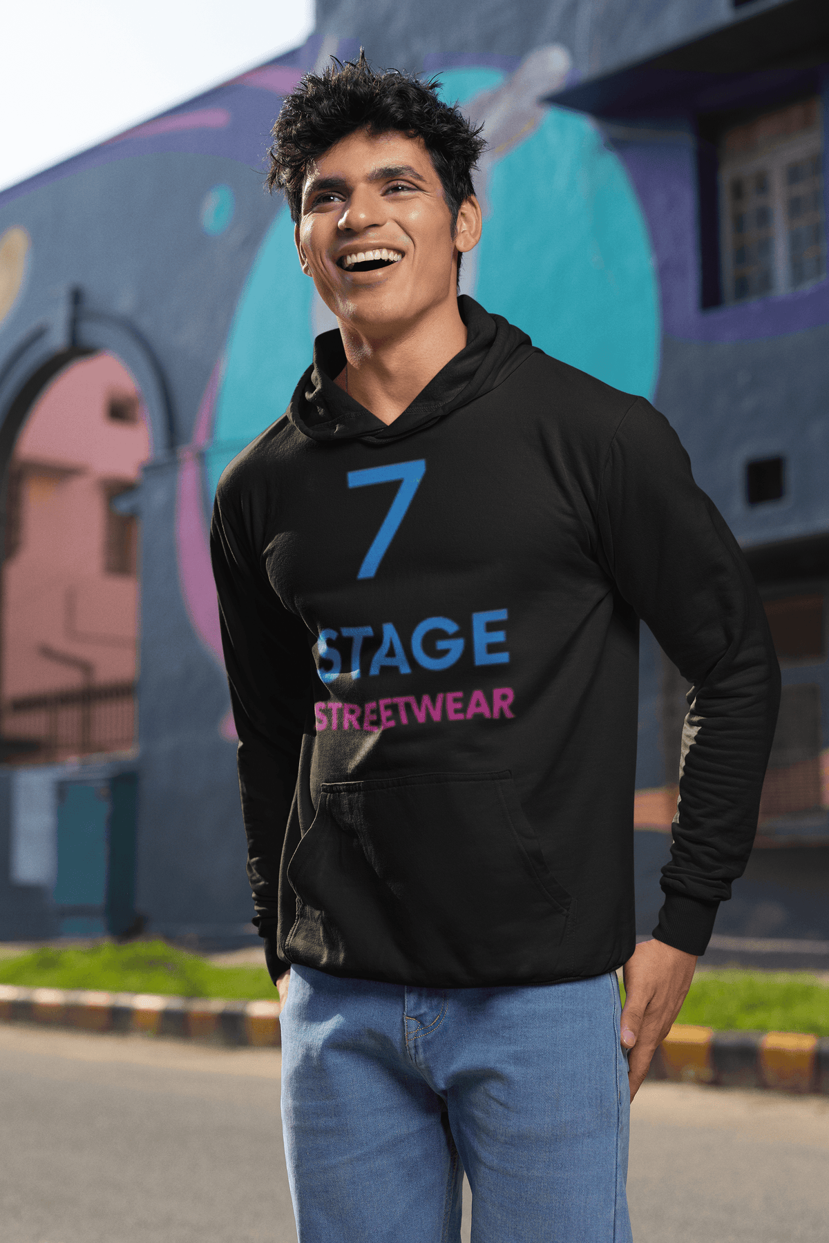 7 Stage hoodie worn by man posing by street happy expression