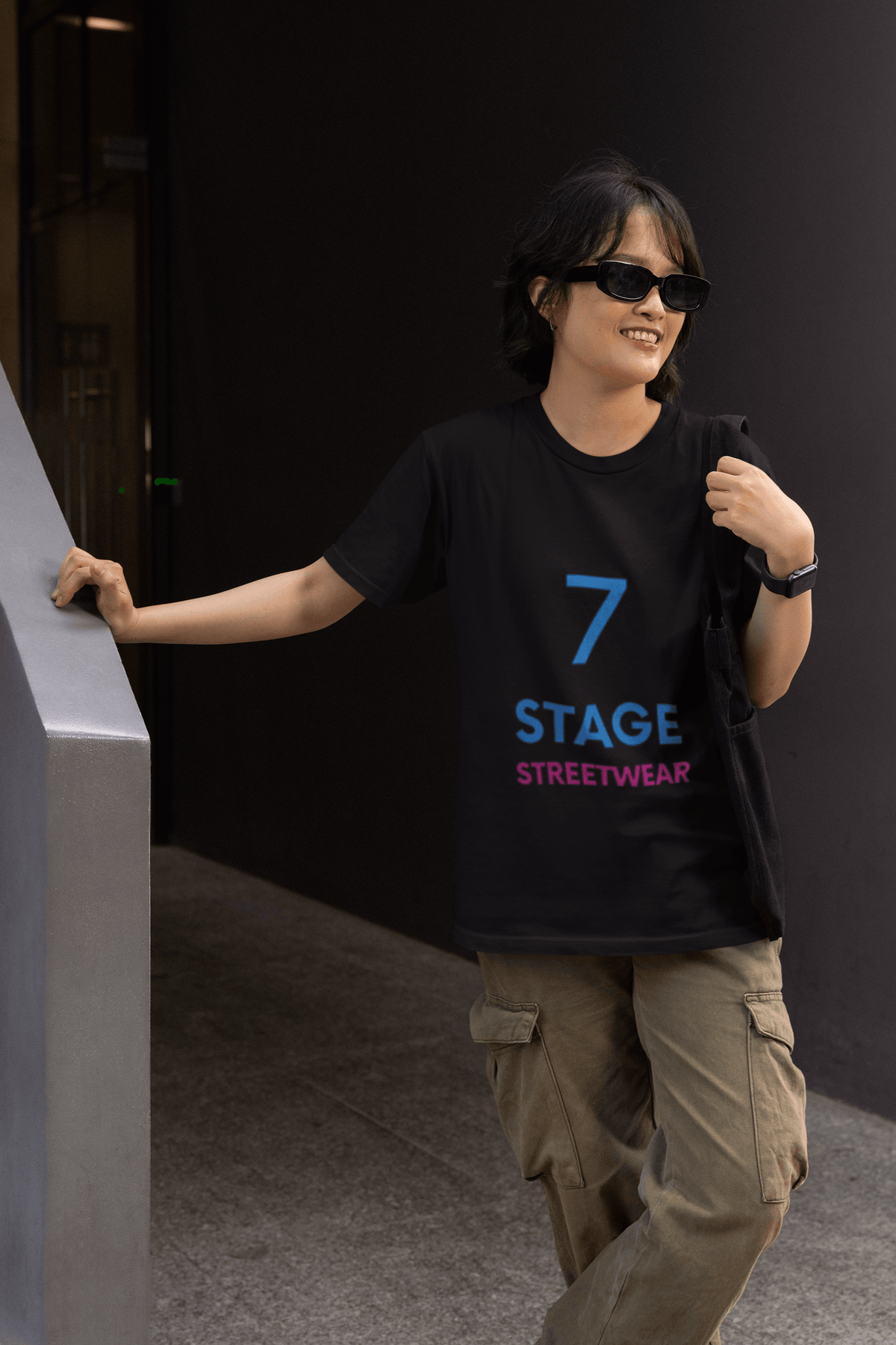 7 Stage Streetwear graphic t-shirt worn by smiling woman dark sunglasses