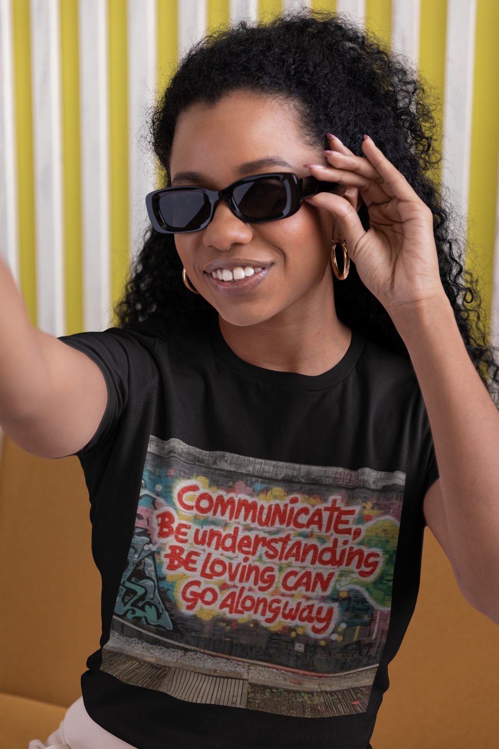 3 Stages of Being Kind positive message graphic t-shirt worn by curly haired woman sunglasses