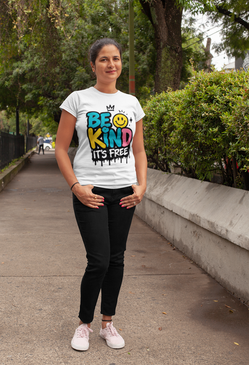 Be Kind It's Free positive message graphic t-shirt worn by kind looking woman posing park lane