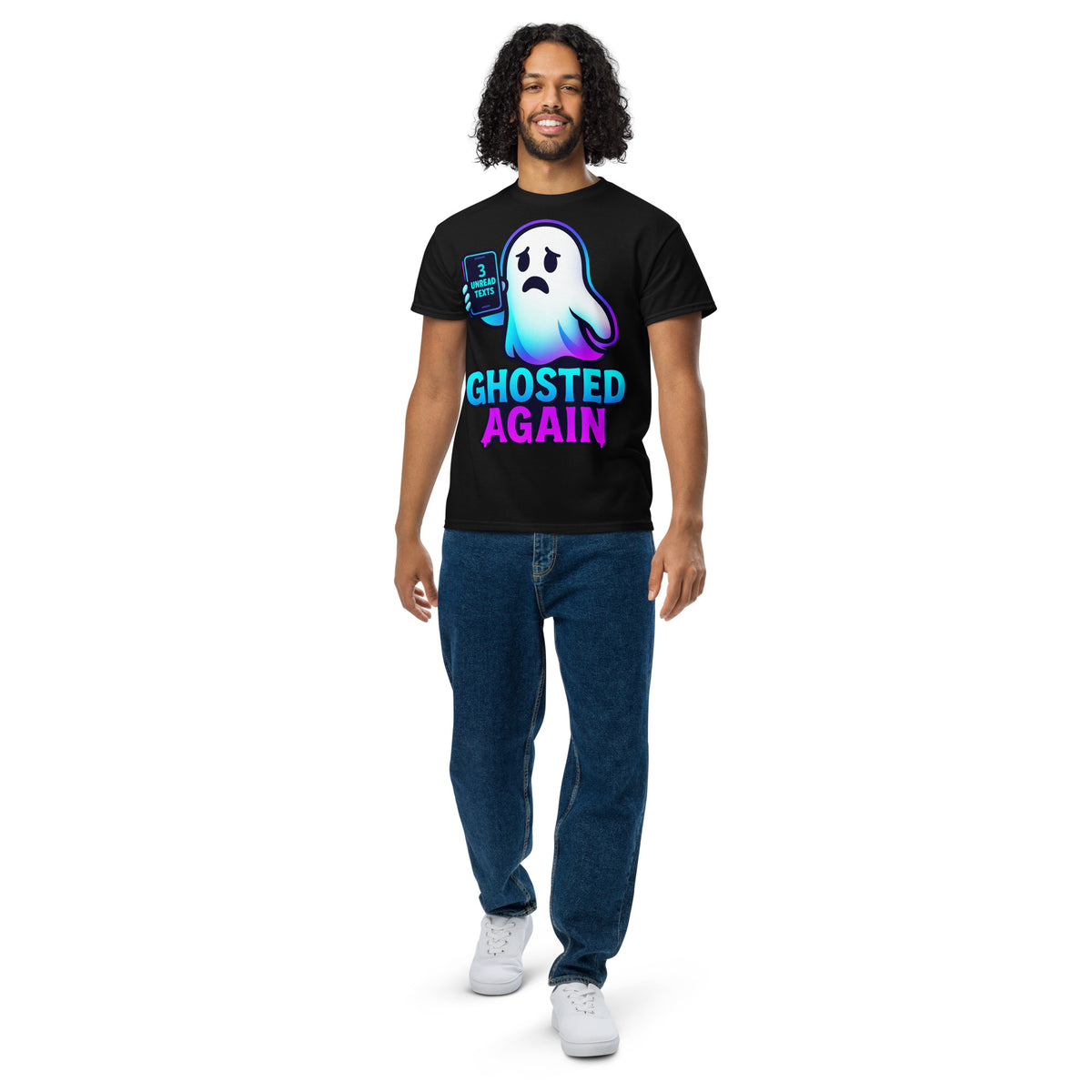 A man modeling a black graphic t-shirt with a ghost design and the text 'GHOSTED AGAIN' in neon blue and pink, paired with blue jeans and white sneakers on a white background.