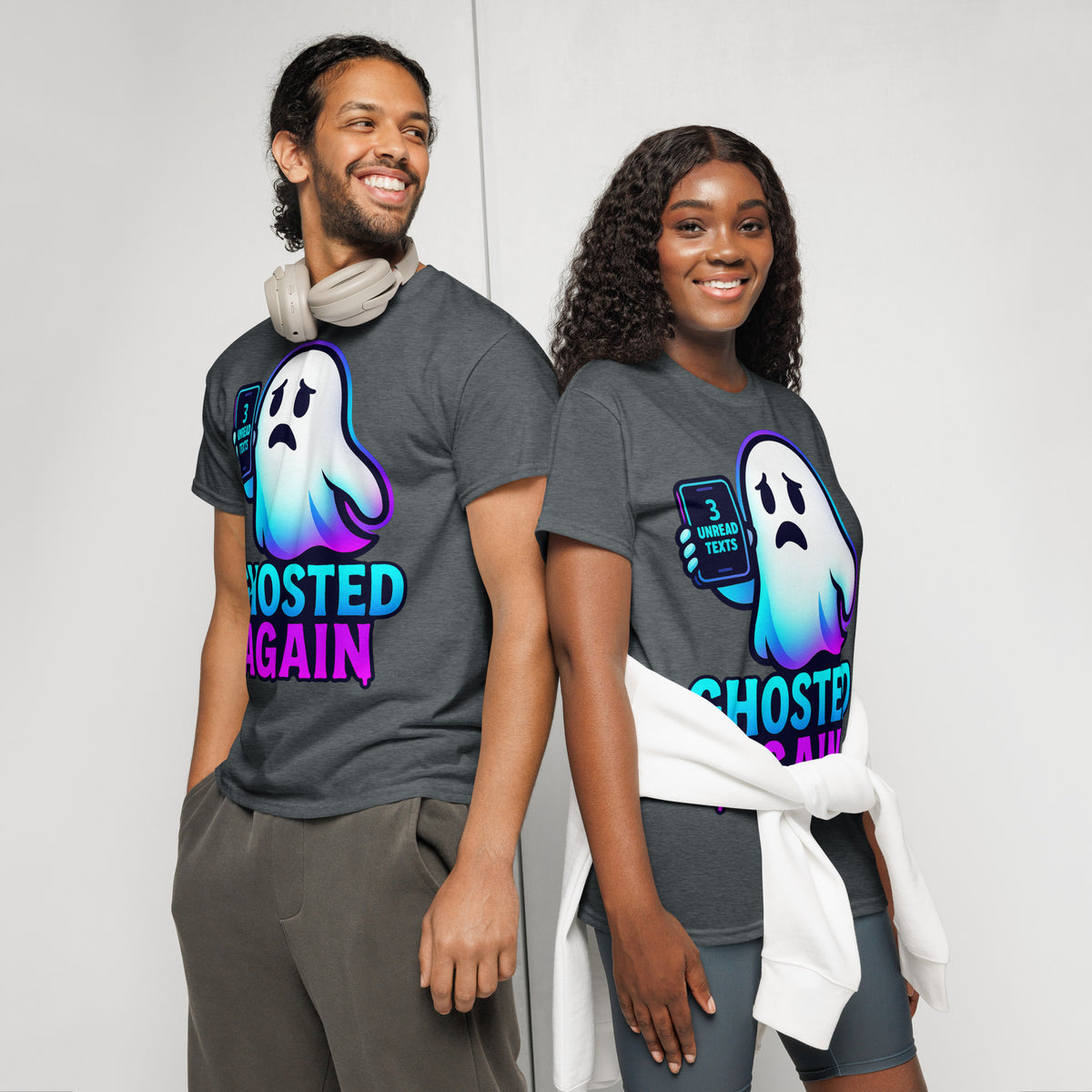 Two models wearing matching dark gray graphic t-shirts with a ghost design and the text 'GHOSTED AGAIN'.